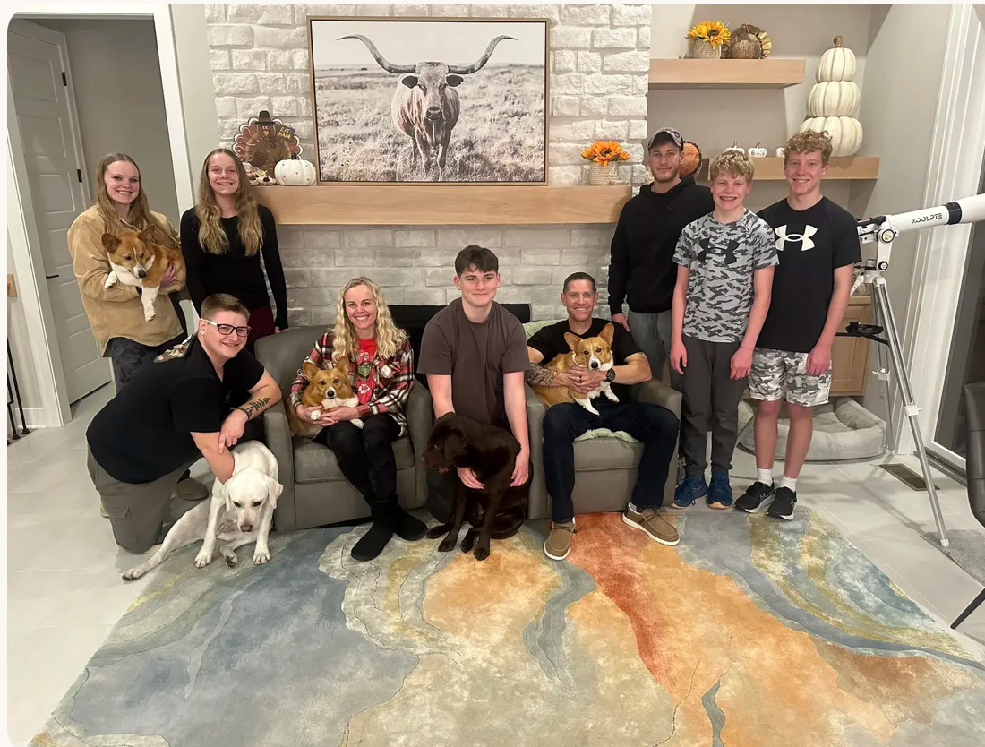 Rebecca with her husband Doug, their children, and their corgis and labs at home