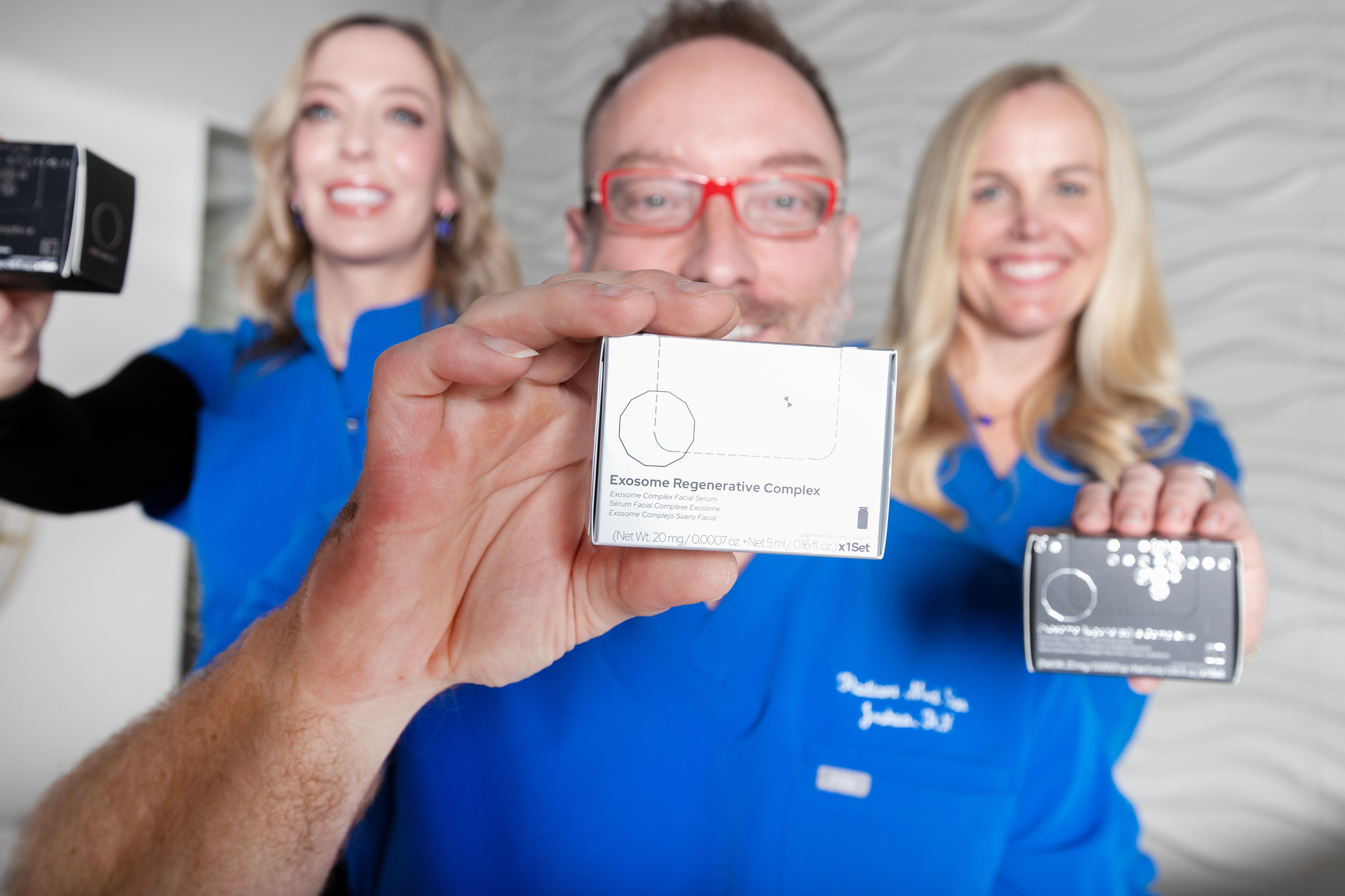 Radiant Med Spa team holding Xeomin® and skincare products